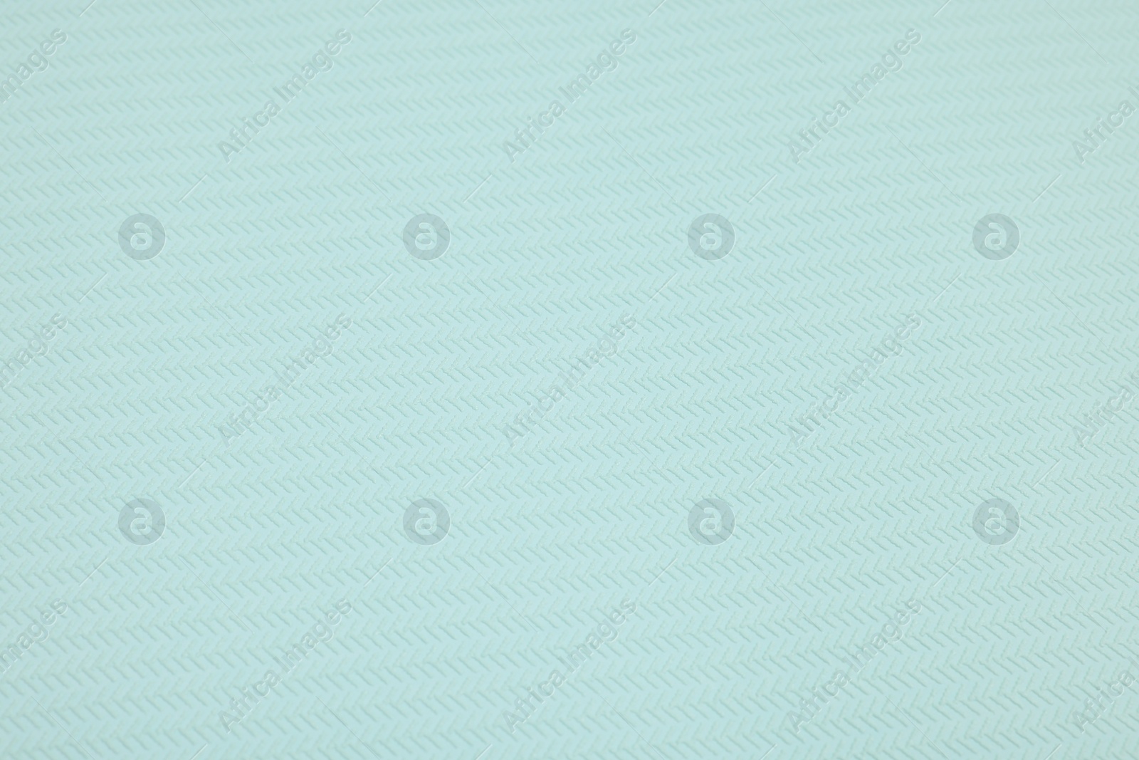 Photo of Stylish light turquoise wallpaper as background, closeup