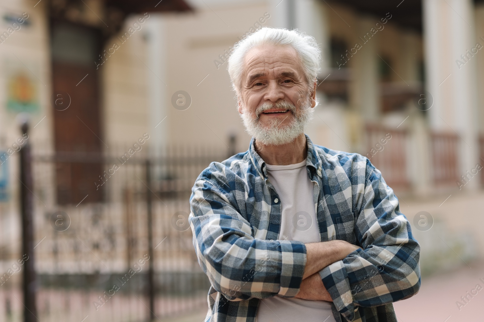 Photo of Portrait of happy grandpa with grey hair outdoors