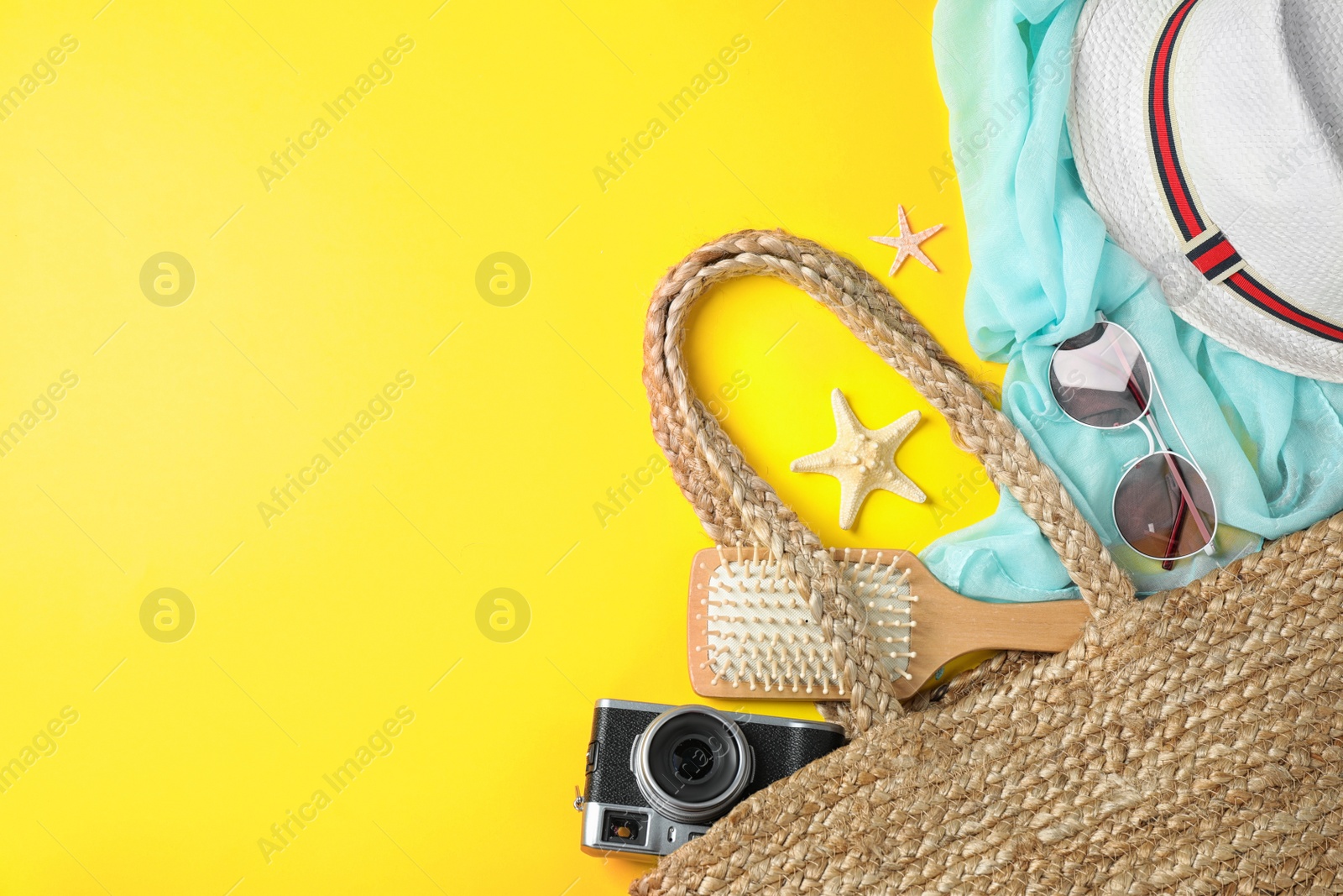 Photo of Composition with beach accessories and space for text on yellow background, flat lay