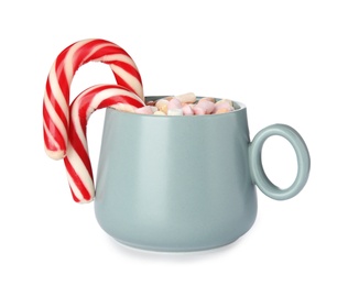 Photo of Cup of tasty cocoa with marshmallows and Christmas candy canes isolated on white