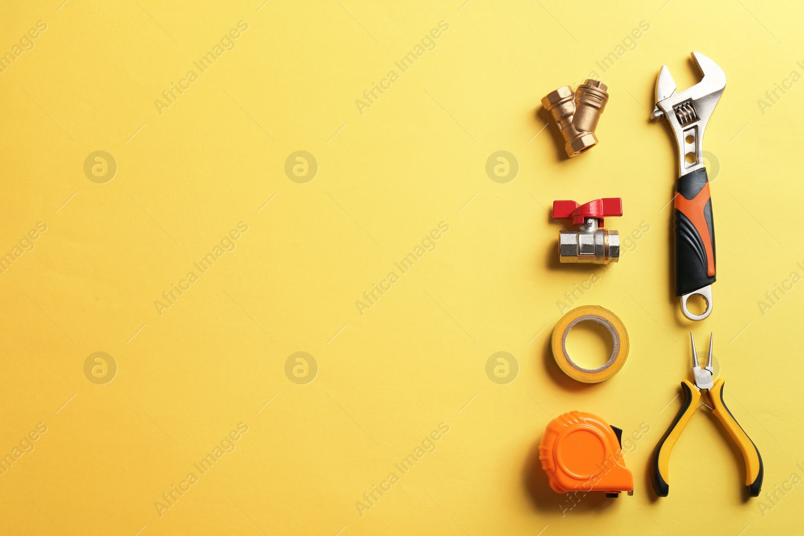 Photo of Flat lay composition with plumber's tools and space for text on color background