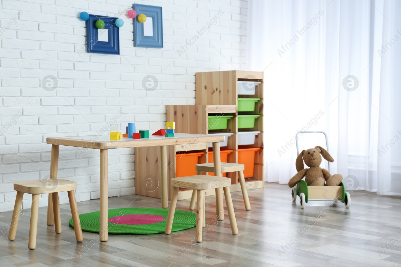 Photo of Modern child room interior with table and stools