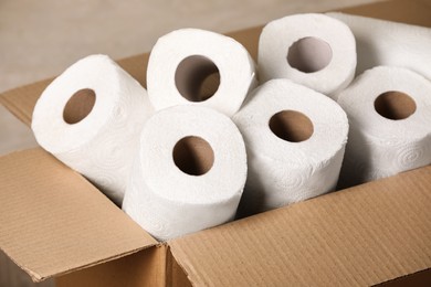 Rolls of white paper towels in cardboard box