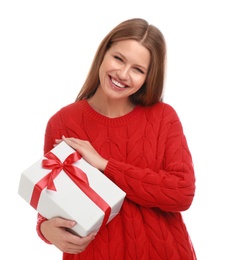 Happy young woman with Christmas gift on white background