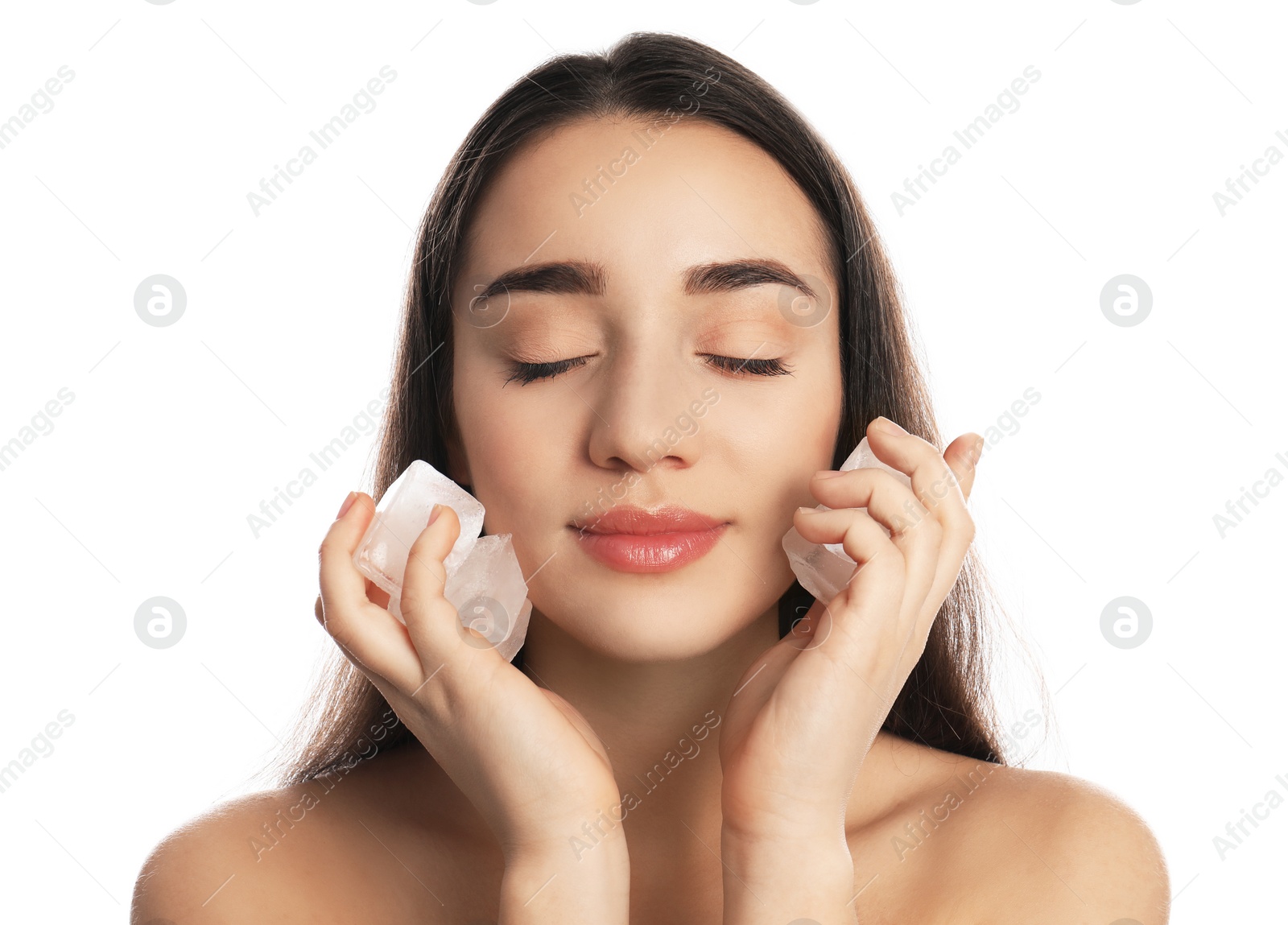 Photo of Young woman with ice cubes on white background. Skin care