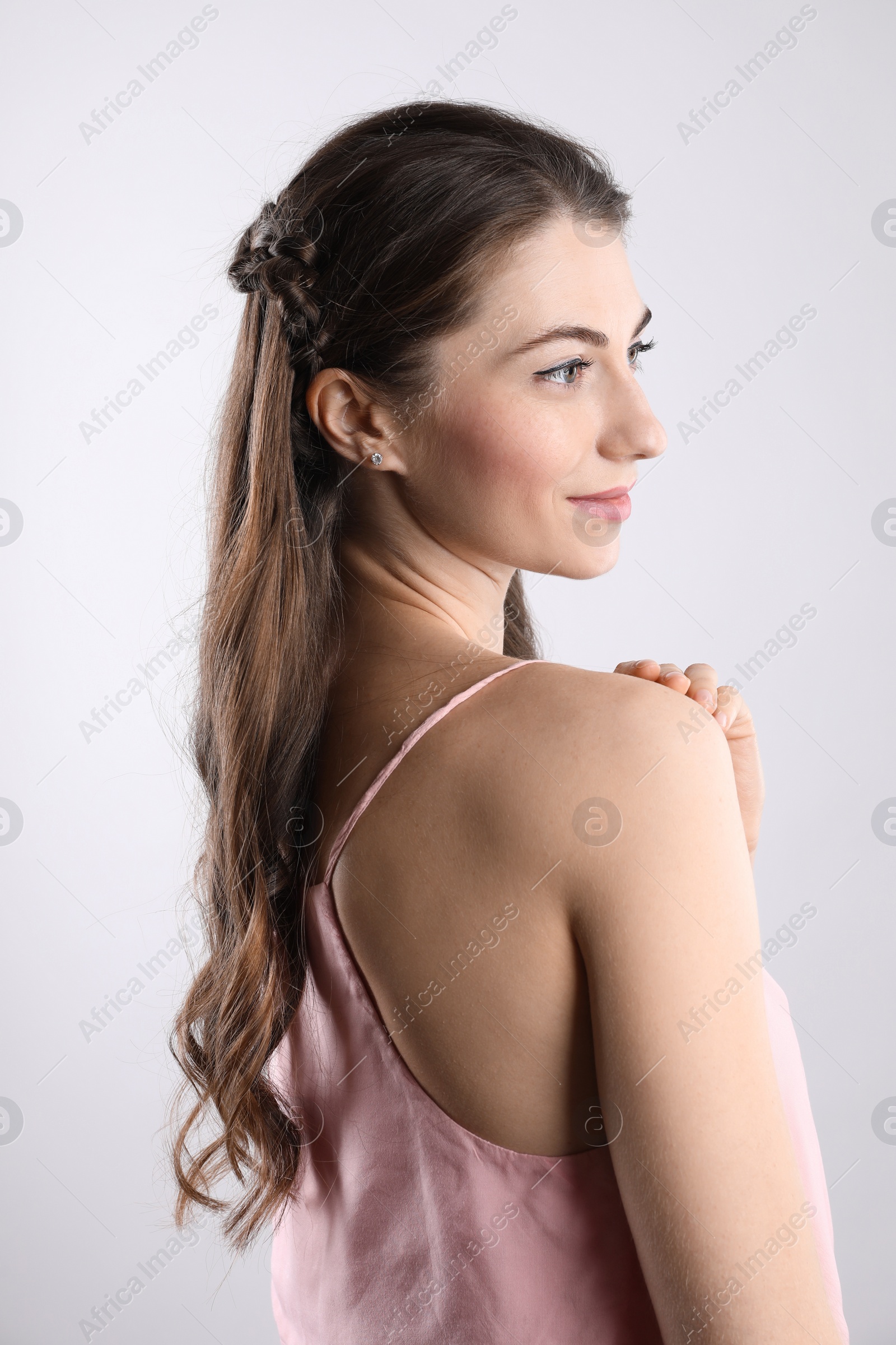 Photo of Woman with wavy hair on light background