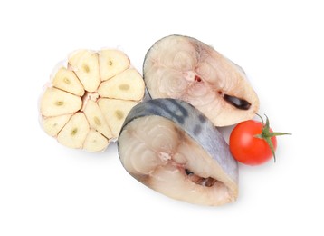 Pieces of mackerel fish with cherry tomato and garlic on white background, top view