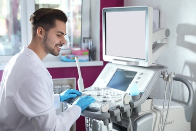 Photo of Sonographer using modern ultrasound machine in clinic