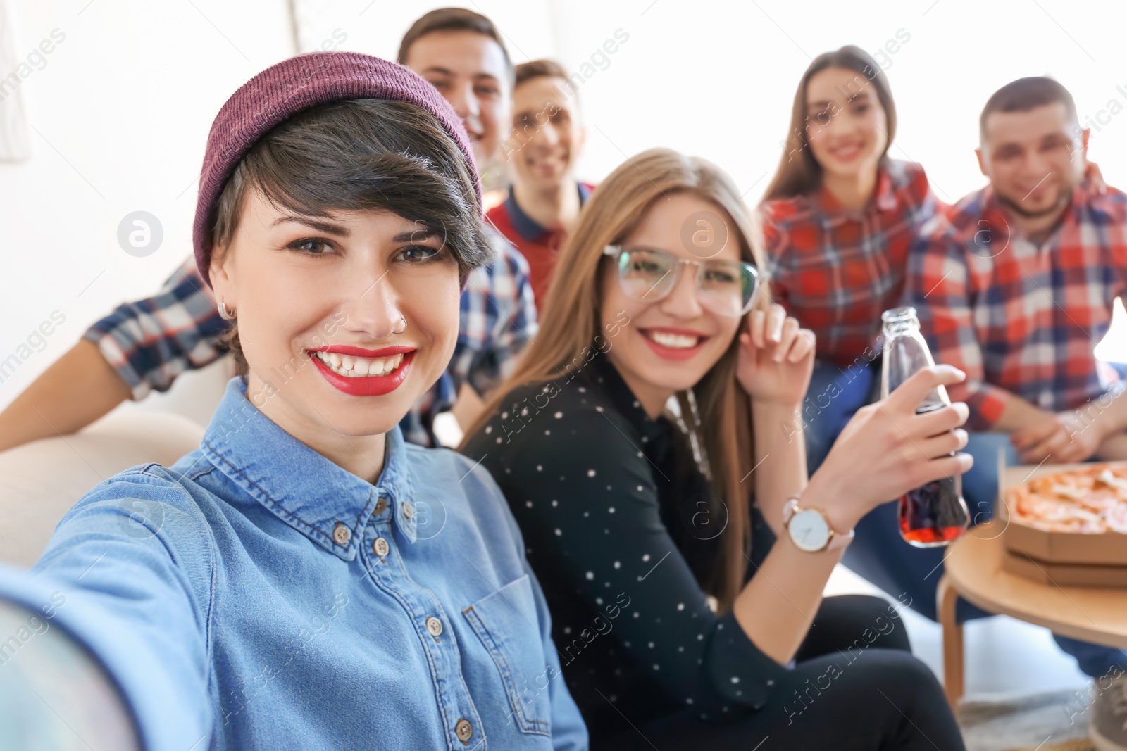 Photo of Happy friends taking selfie indoors