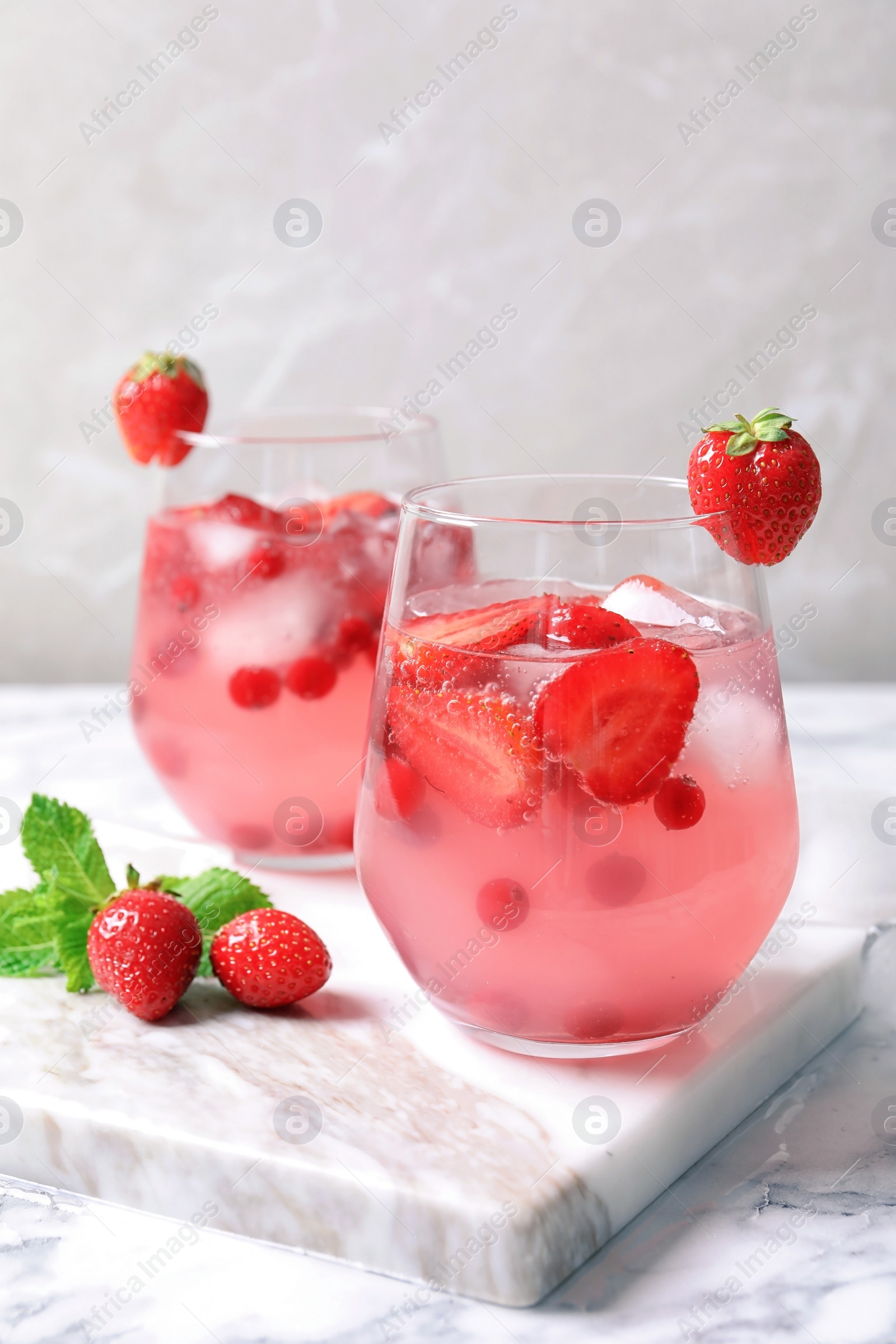 Photo of Glasses of natural lemonade with berries on table