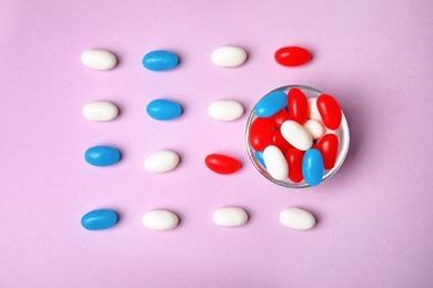 Photo of Flat lay composition with bowl of jelly beans on color background