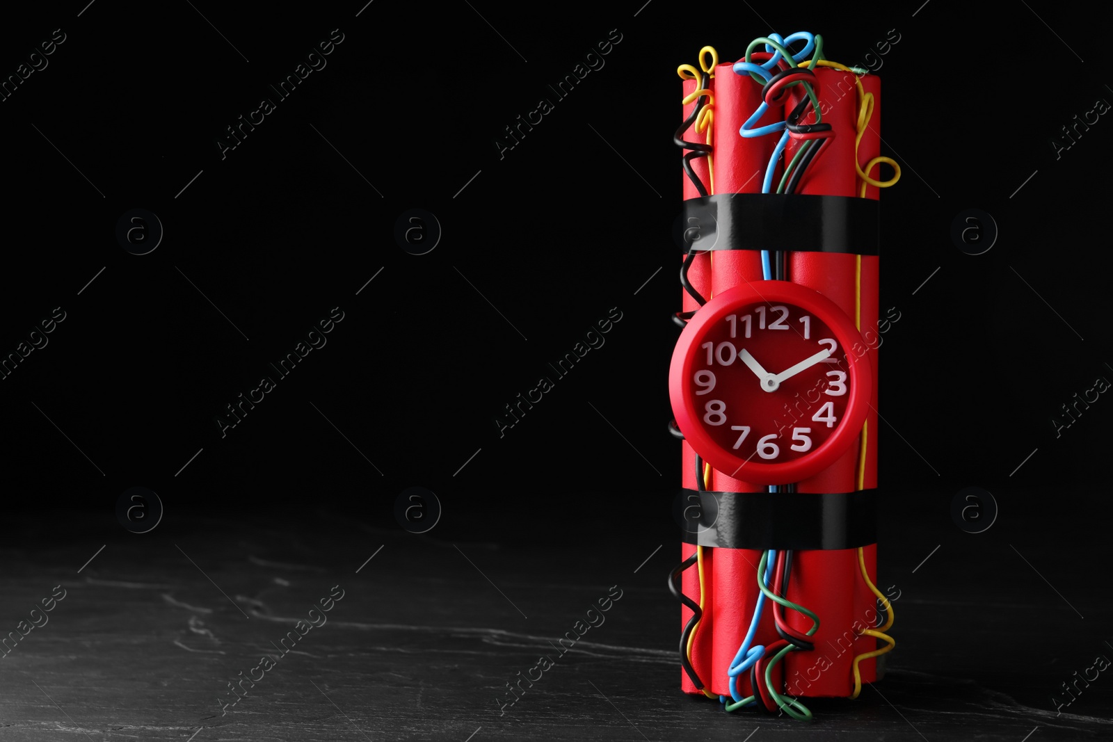 Photo of Explosive dynamite time bomb on black background. Space for text