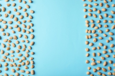 Photo of Composition with peanuts and space for text on color background, top view