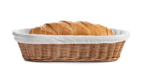 Photo of Sliced tasty fresh bread in wicker basket on white background