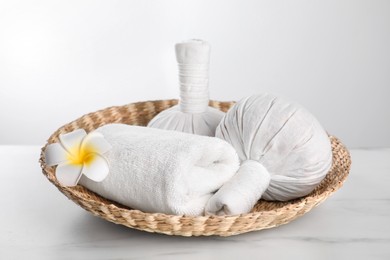 Spa composition with care products on white marble table