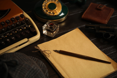 Photo of Composition with vintage detective items on wooden table, closeup