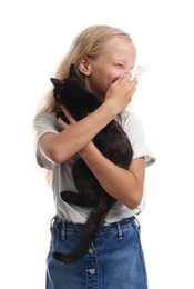 Photo of Little girl with cat suffering from allergy on white background