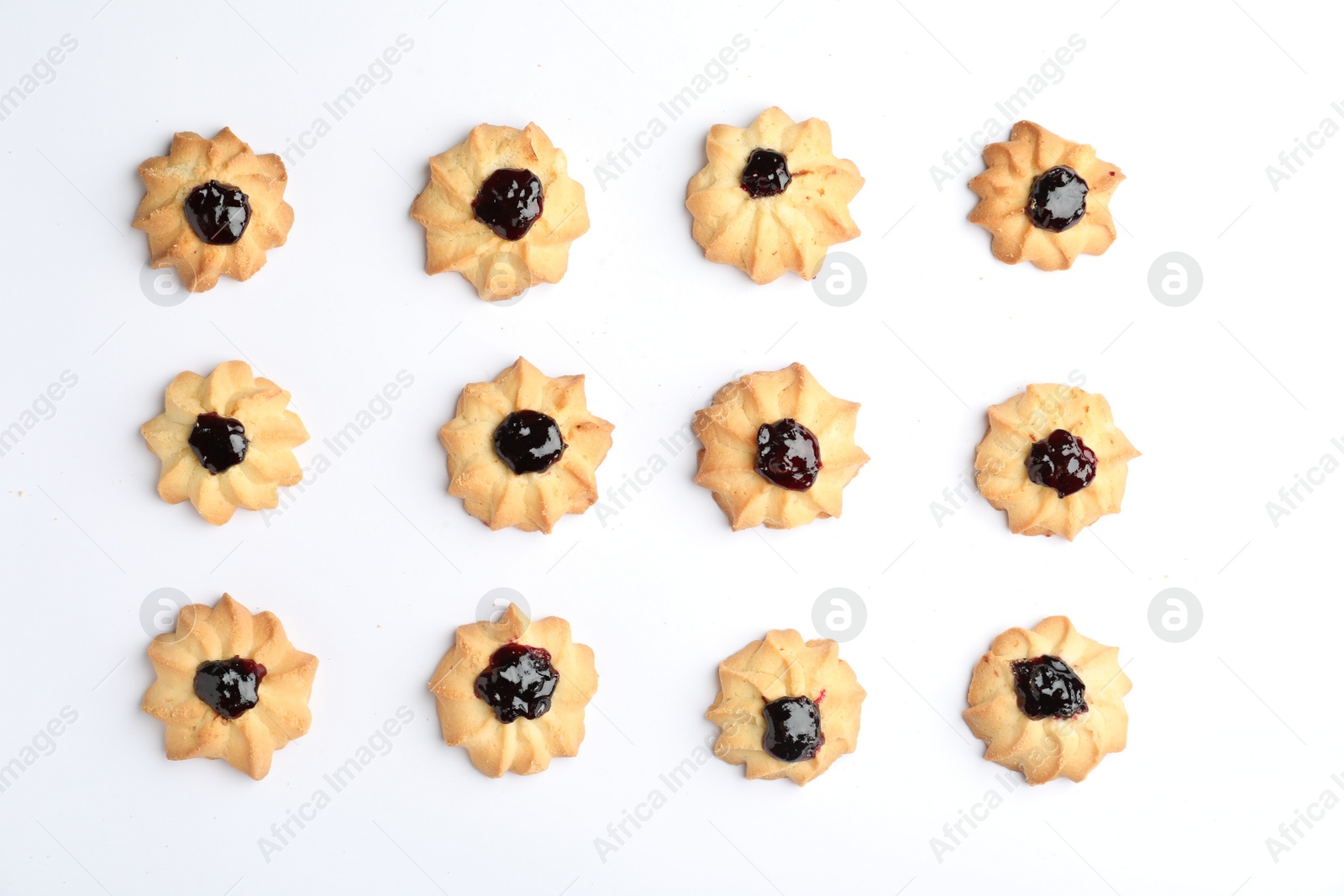 Photo of Tasty shortbread cookies with jam on white background, top view