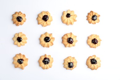 Tasty shortbread cookies with jam on white background, top view