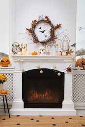 Modern room with fireplace decorated for Halloween. Festive interior
