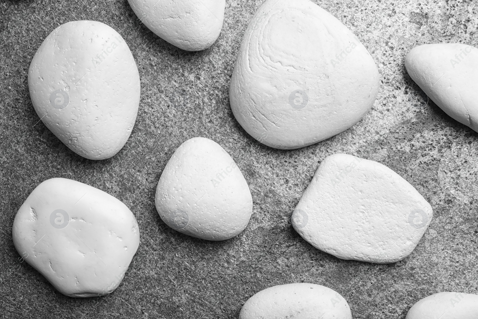 Photo of Zen stones on grey background, top view