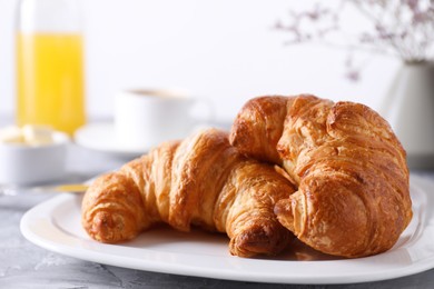 Photo of Tasty breakfast. Fresh croissants on grey table, closeup