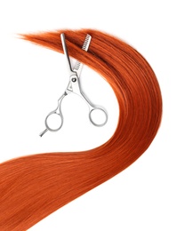 Photo of Red hair and thinning scissors on white background, top view. Hairdresser service