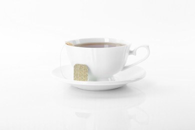 Photo of Tasty tea in cup on white background