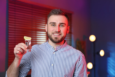 Young man with Mexican Tequila shot in bar