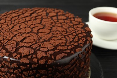 Photo of Delicious chocolate truffle cake on table, closeup