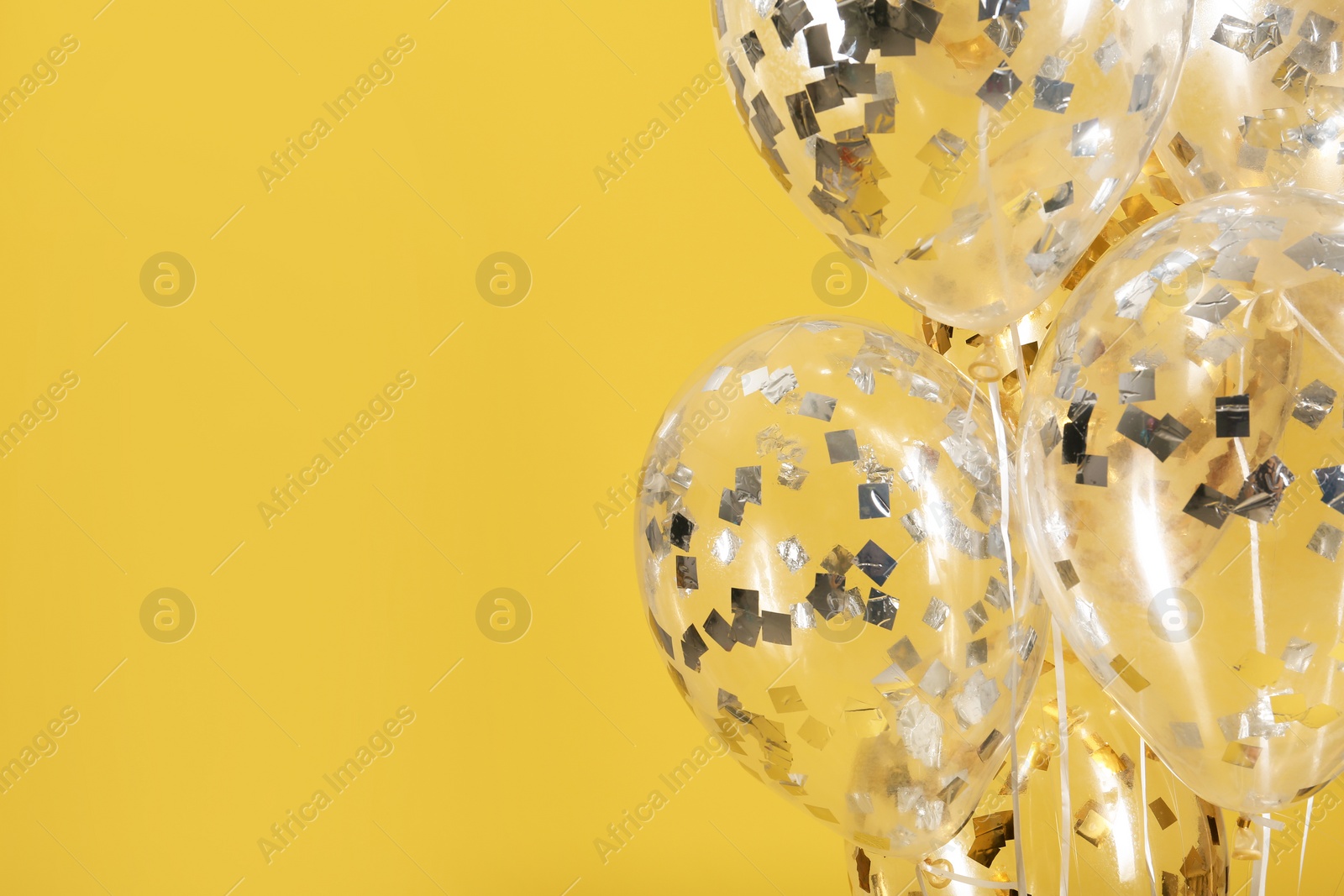 Photo of Balloons with sparkles on color background. Space for text