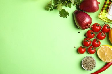 Photo of Flat lay composition with ingredients for cooking on green background. Space for text