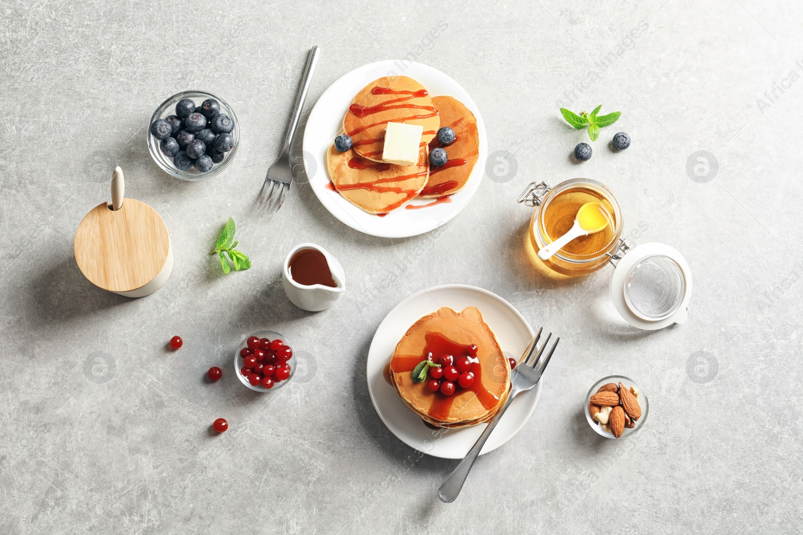 Photo of Flat lay composition with tasty pancakes on grey background