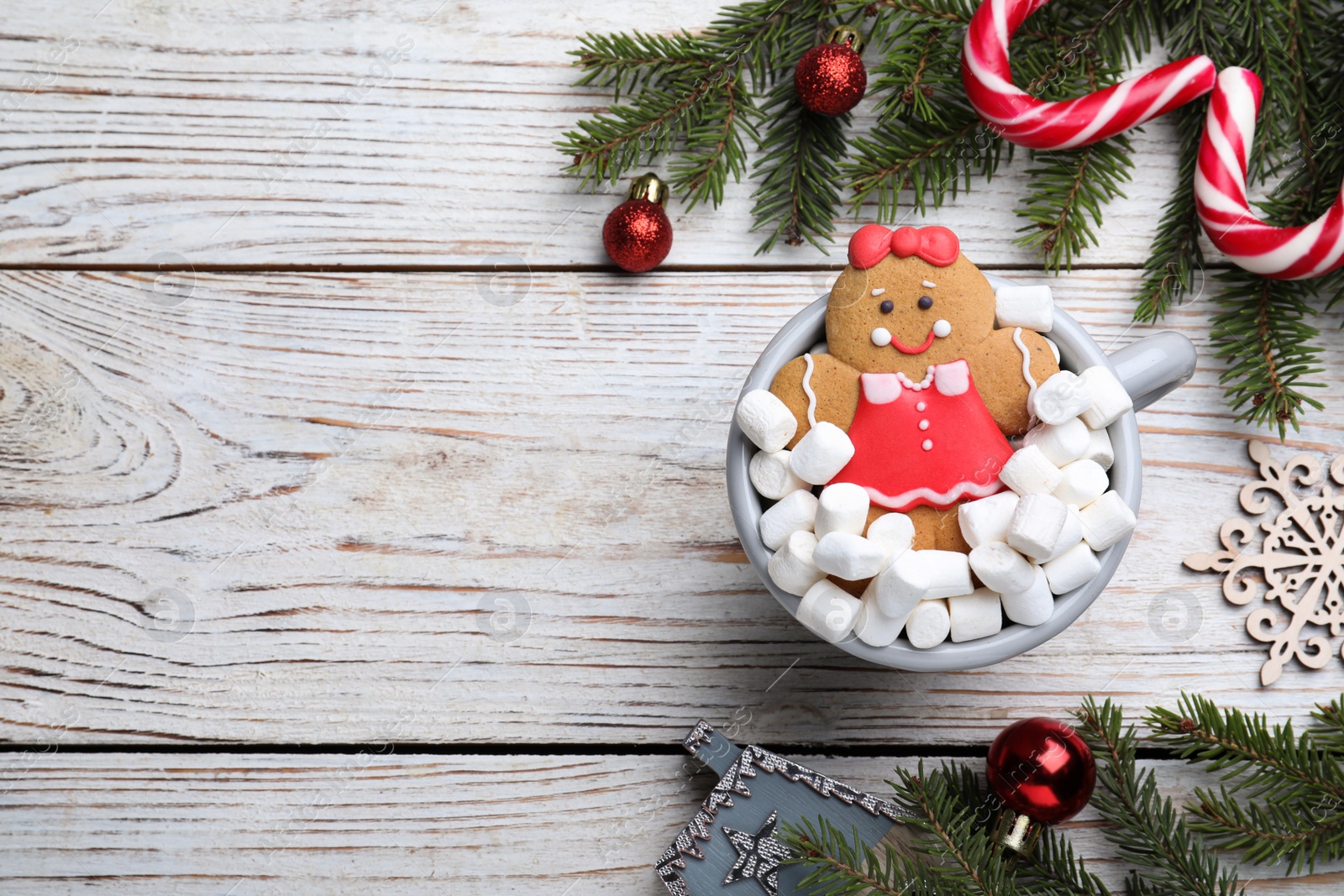 Photo of Flat lay composition with gingerbread girl on white wooden table, space for text