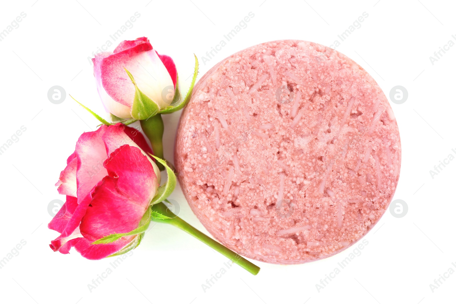Photo of Solid shampoo bar and roses on white background, top view. Hair care