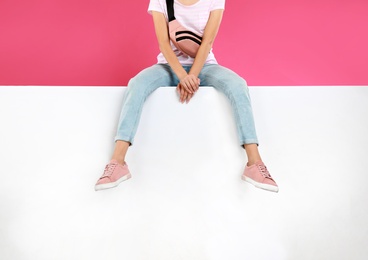 Photo of Woman wearing stylish shoes on color background, closeup