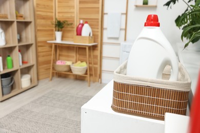 Detergent on washing machine in laundry room, space for text