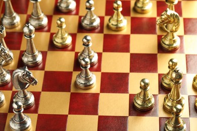 Photo of Wooden chessboard with different beautiful game pieces