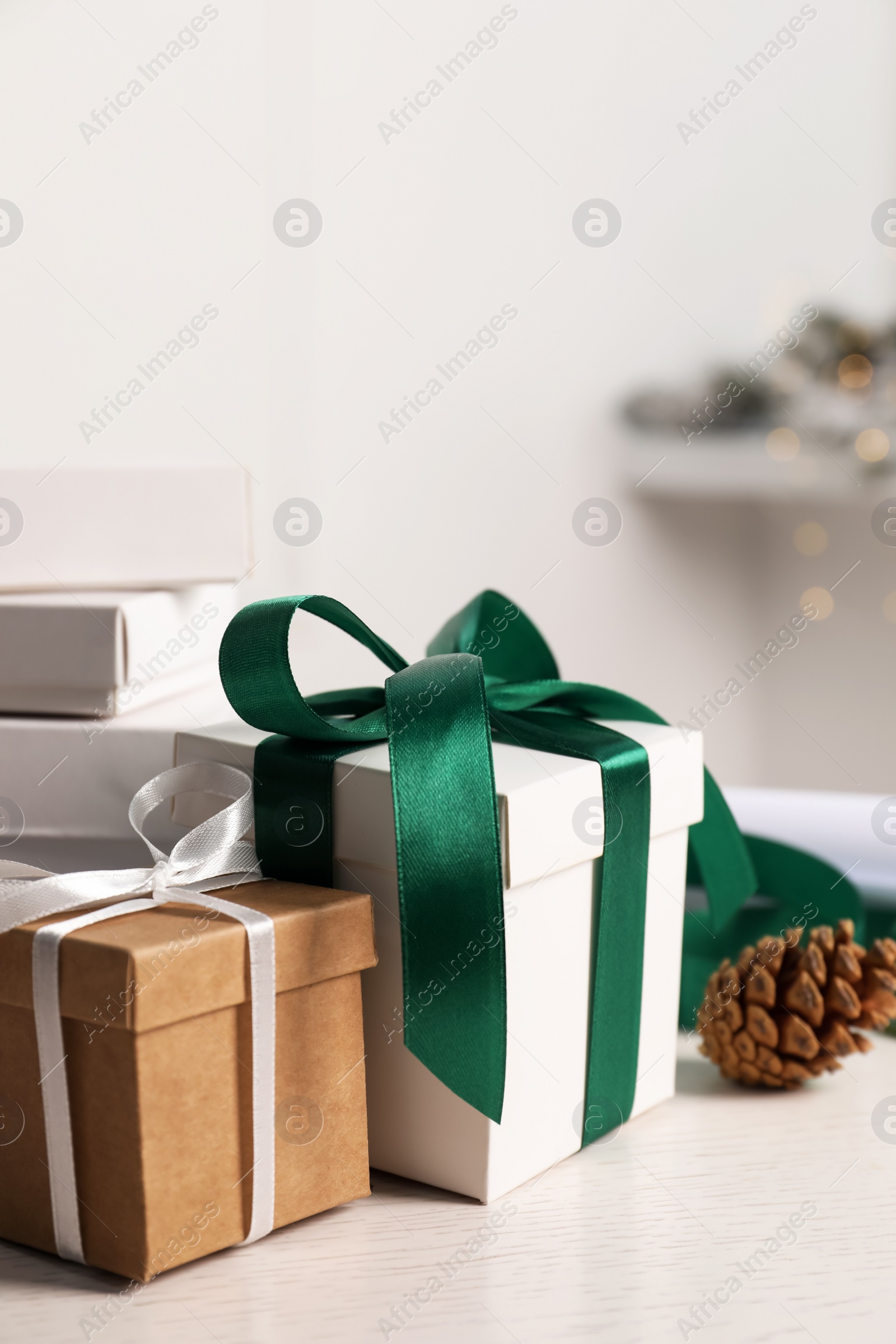 Photo of Beautiful gift boxes and Christmas decorations on white table