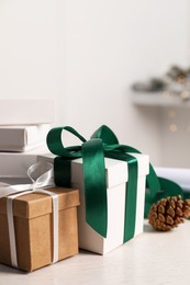 Beautiful gift boxes and Christmas decorations on white table