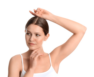 Photo of Young beautiful woman showing armpit with smooth clean skin on white background