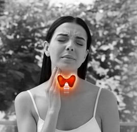 Image of Young woman with thyroid gland disease outdoors