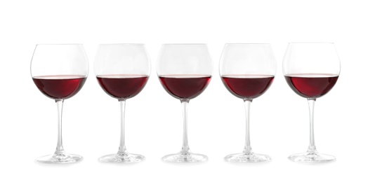 Photo of Glasses with red wine on white background