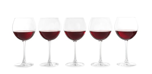 Glasses with red wine on white background