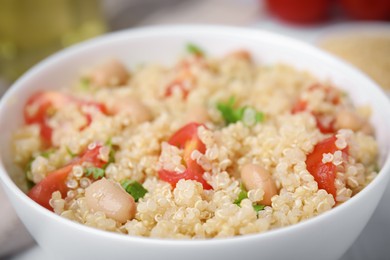 Delicious quinoa salad with tomatoes, beans and parsley, closeup