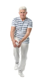 Full length portrait of senior man having knee problems on white background