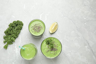 Photo of Tasty kale smoothie on light grey marble table, flat lay. Space for text