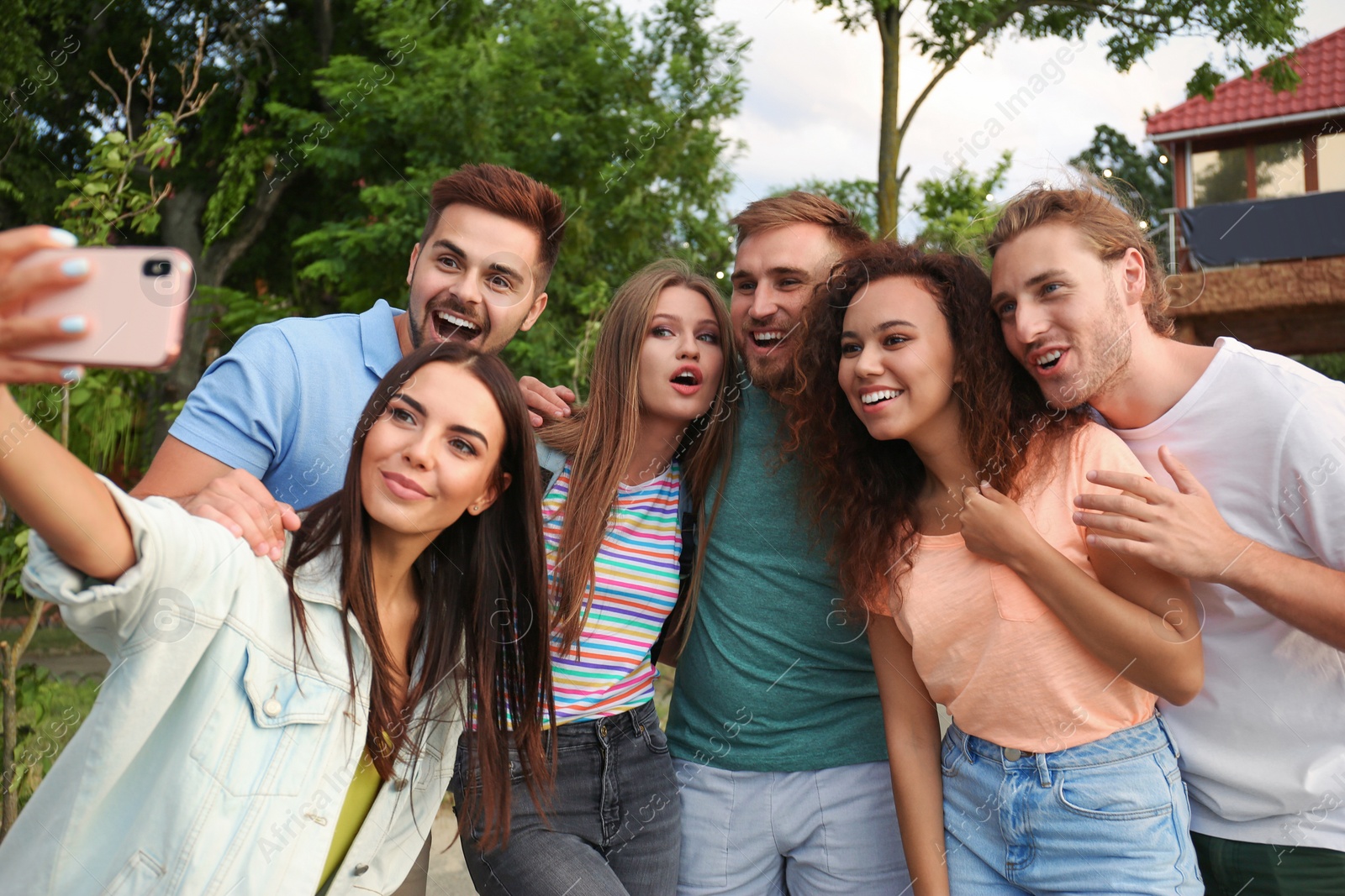Photo of Happy young people taking selfie in park