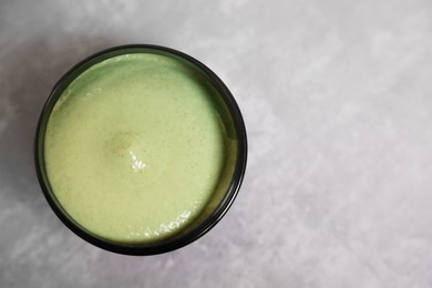 Natural body scrub on grey table, top view. Space for text