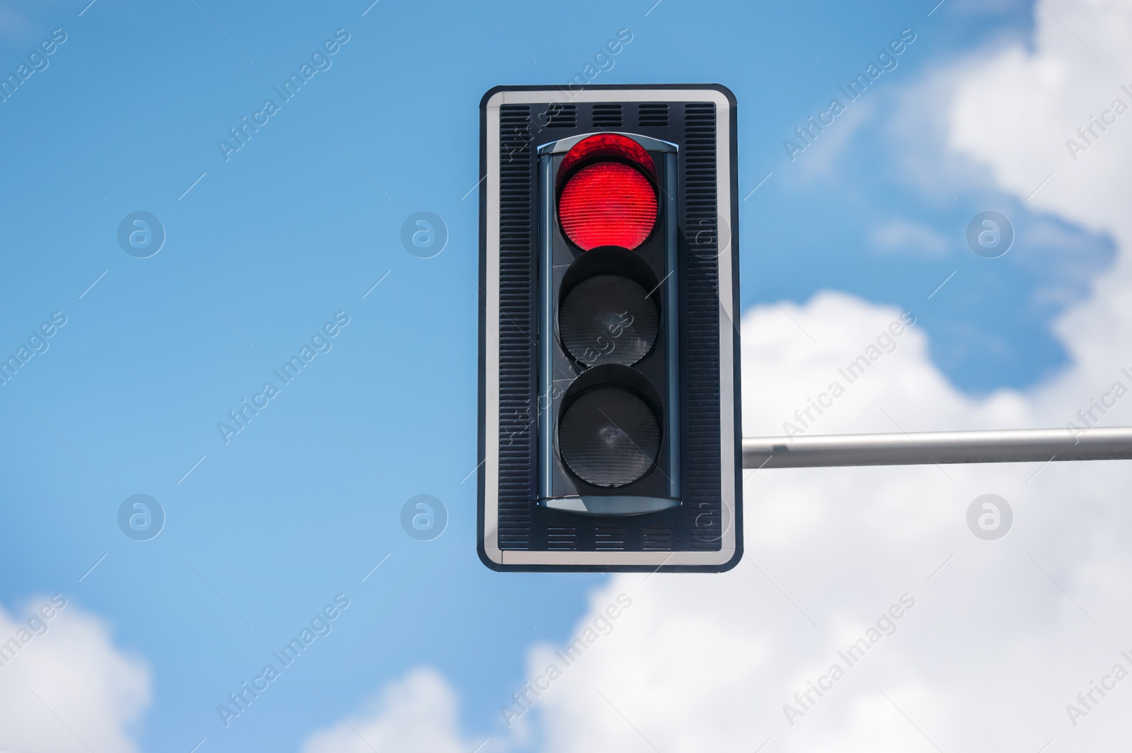 Photo of Traffic light against blue sky, space for text